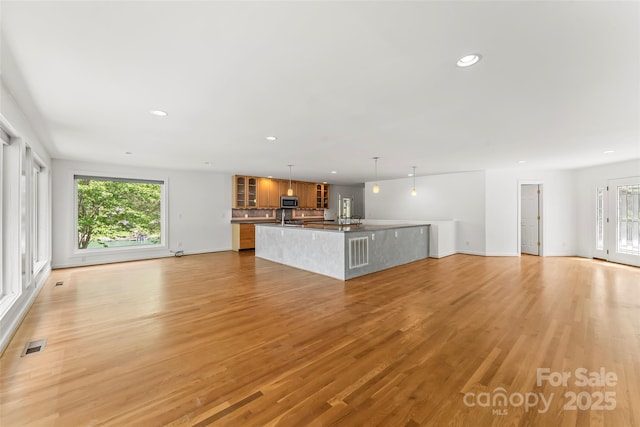2218 Mallard Cove Dr, Nebo, NC 28761 - unfurnished living room with healthy amount of natural light, recessed lighting, light wood finished floors, and baseboards