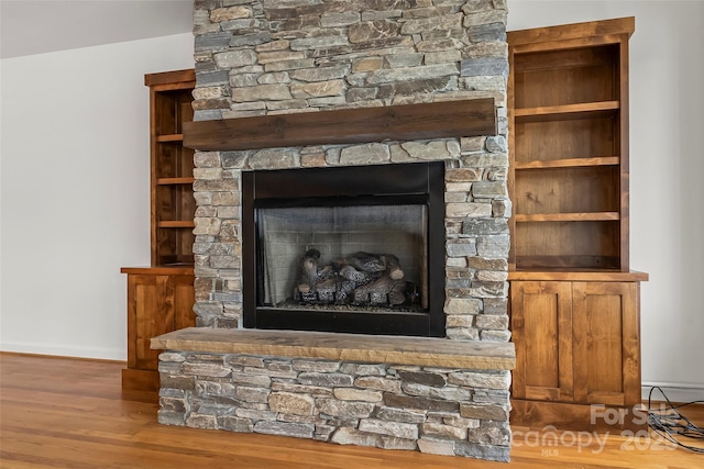 2218 Mallard Cove Dr, Nebo, NC 28761 - detailed view of a stone fireplace, baseboards, and wood finished floors