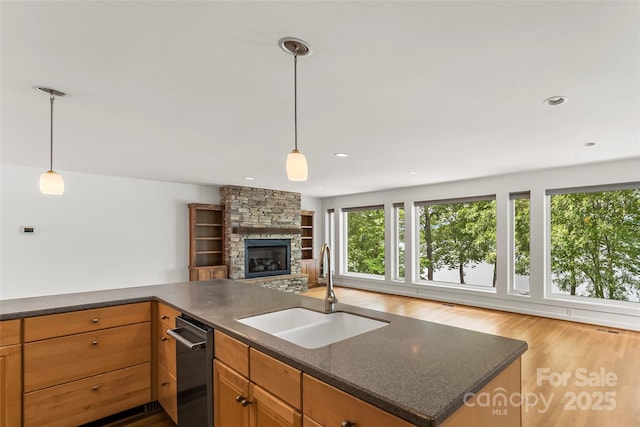 2218 Mallard Cove Dr, Nebo, NC 28761 - kitchen with a sink, open floor plan, dishwashing machine, wood finished floors, and a stone fireplace
