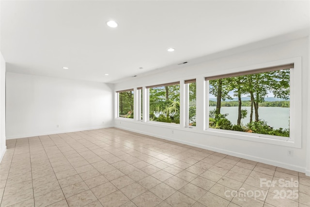 2218 Mallard Cove Dr, Nebo, NC 28761 - unfurnished room with light tile patterned floors, baseboards, recessed lighting, and a water view