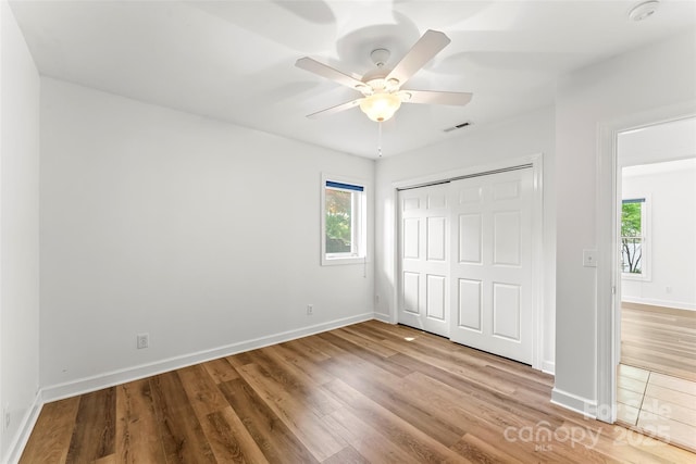 2218 Mallard Cove Dr, Nebo, NC 28761 - unfurnished bedroom with multiple windows, wood finished floors, and baseboards