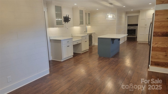 kitchen featuring dark wood finished floors, white cabinetry, glass insert cabinets, a kitchen island, and recessed lighting