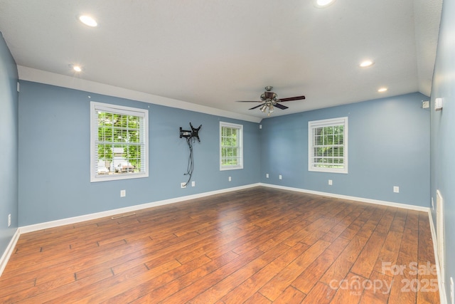 spare room with dark wood-type flooring, recessed lighting, ceiling fan, and baseboards