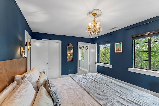 26 White Oak Rd, Asheville, NC 28803 - bedroom with a chandelier, baseboards, and a closet