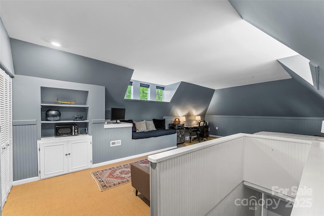 26 White Oak Rd, Asheville, NC 28803 - living area featuring built in features, light colored carpet, and a wainscoted wall