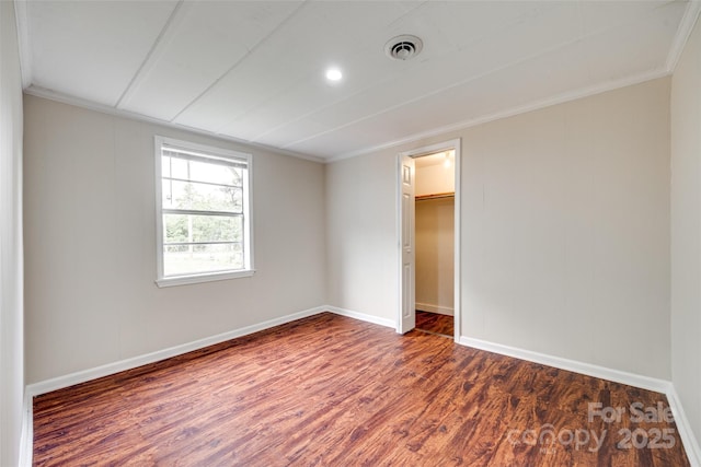 275 N Garrison Rd, Rock Hill, SC 29730 - unfurnished bedroom featuring dark wood-type flooring, baseboards, ornamental molding, a walk in closet, and a closet