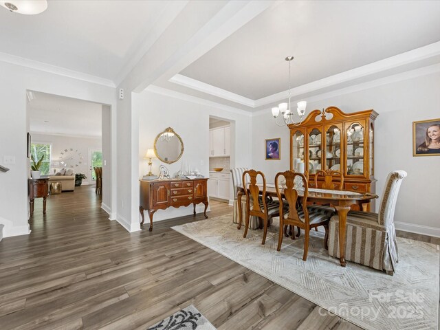 603 Southstone Dr, Matthews, NC 28104 - dining space with a chandelier, wood finished floors, crown molding, and baseboards