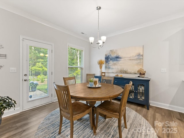 603 Southstone Dr, Matthews, NC 28104 - dining room featuring a chandelier, wood finished floors, crown molding, and baseboards