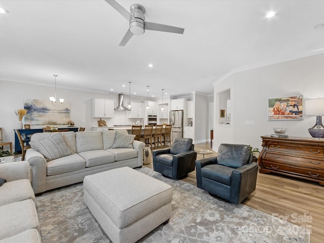 603 Southstone Dr, Matthews, NC 28104 - living area with light wood-style floors, recessed lighting, ceiling fan, a chandelier, and crown molding