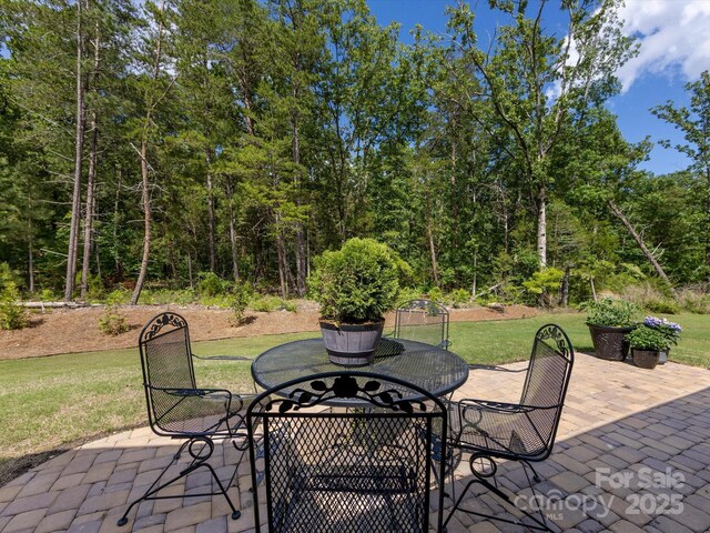 603 Southstone Dr, Matthews, NC 28104 - view of patio / terrace with outdoor dining space and a forest view