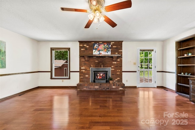 113 Helena St, Mount Holly, NC 28120 - unfurnished living room with wood finished floors, baseboards, and a ceiling fan