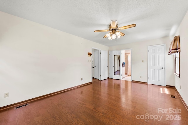 113 Helena St, Mount Holly, NC 28120 - unfurnished bedroom featuring wood finished floors, baseboards, a ceiling fan, and a textured ceiling