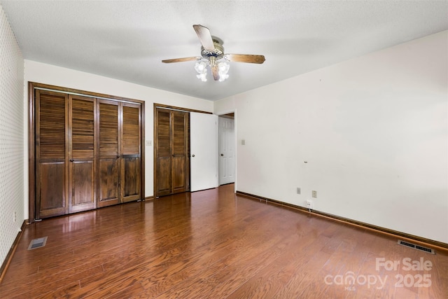 113 Helena St, Mount Holly, NC 28120 - unfurnished bedroom with wood finished floors, multiple closets, baseboards, and ceiling fan