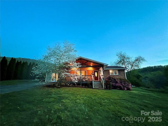 11 Chaz Ln, Candler, NC 28715 - back of property with a lawn and a porch