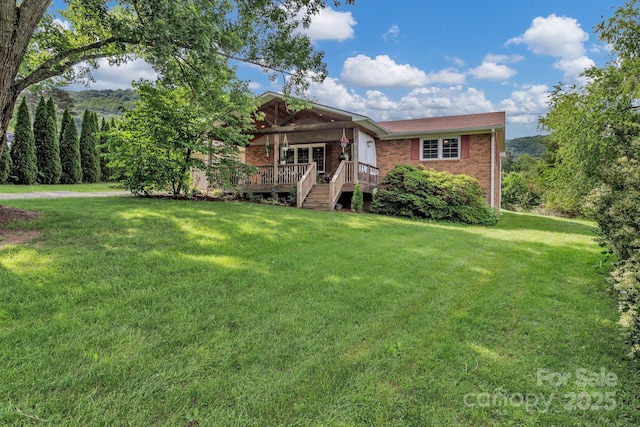 11 Chaz Ln, Candler, NC 28715 - view of front facade with brick siding, a front yard, and a wooden deck