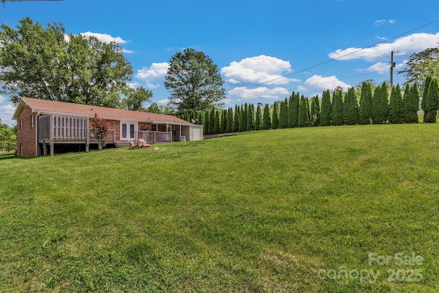 11 Chaz Ln, Candler, NC 28715 - view of green lawn featuring a garage and a wooden deck