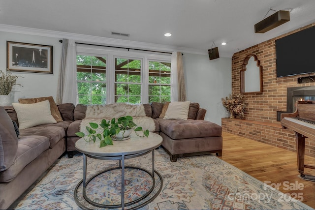 11 Chaz Ln, Candler, NC 28715 - living area with wood finished floors, ornamental molding, a brick fireplace, and recessed lighting