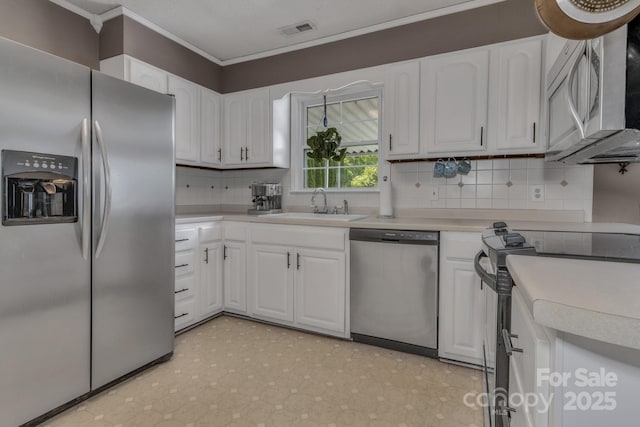 11 Chaz Ln, Candler, NC 28715 - kitchen with appliances with stainless steel finishes, a sink, ornamental molding, tasteful backsplash, and white cabinets