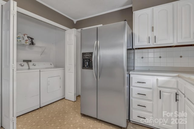 11 Chaz Ln, Candler, NC 28715 - kitchen with stainless steel fridge with ice dispenser, washing machine and clothes dryer, ornamental molding, white cabinetry, and backsplash