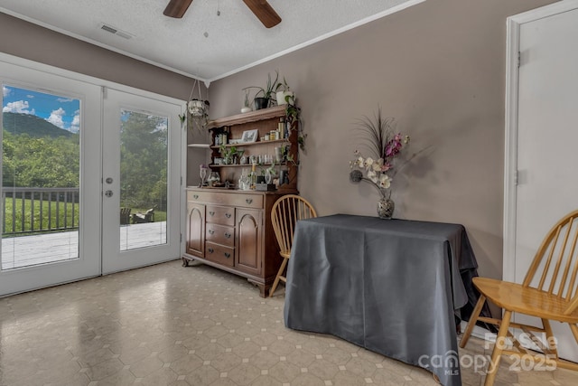 11 Chaz Ln, Candler, NC 28715 - dining area featuring french doors, a ceiling fan, a textured ceiling, light floors, and crown molding