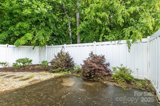 112 Dujon Ct, Mount Holly, NC 28120 - fenced backyard with a patio area