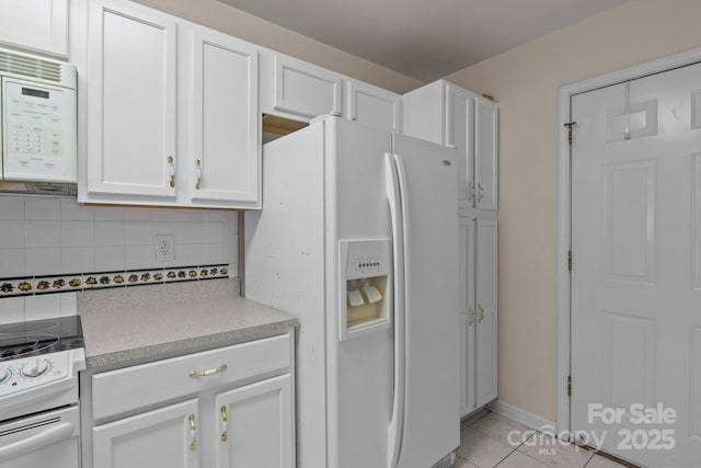 112 Dujon Ct, Mount Holly, NC 28120 - kitchen featuring white appliances, white cabinetry, backsplash, light tile patterned floors, and light countertops