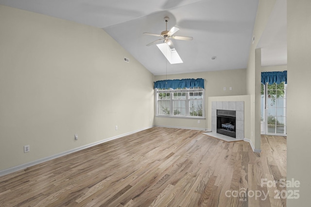 112 Dujon Ct, Mount Holly, NC 28120 - unfurnished living room with ceiling fan, healthy amount of natural light, wood finished floors, a skylight, and high vaulted ceiling