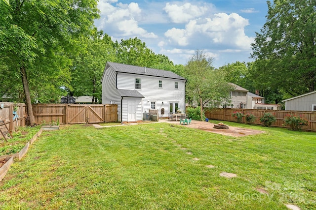 back of property with an outdoor fire pit, a patio, a gate, a vegetable garden, and central AC unit