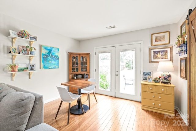 home office with french doors, light wood-style flooring, and baseboards