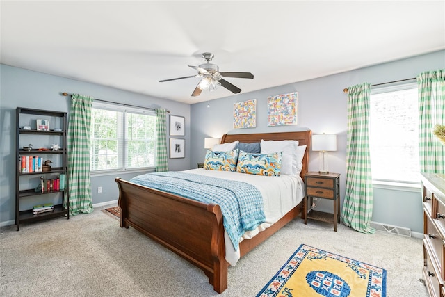 carpeted bedroom featuring baseboards and ceiling fan