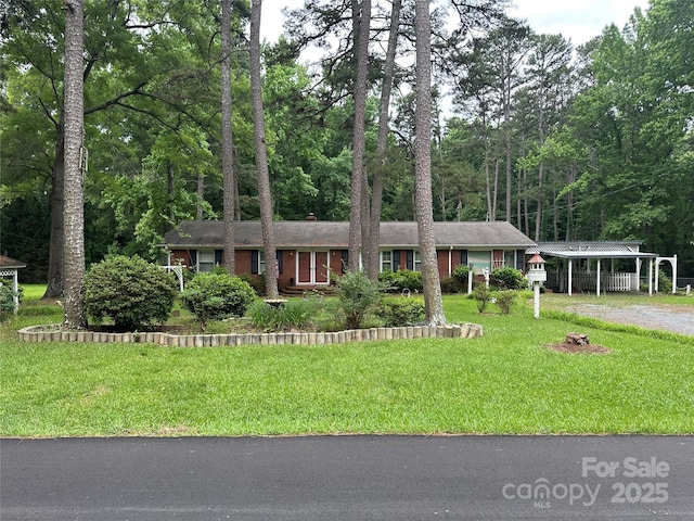 8524 Anette Ave, Mint Hill, NC 28227 - view of front of house with dirt driveway, a front lawn, a carport, and a chimney