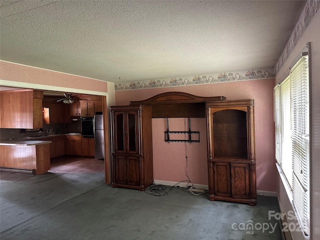 8524 Anette Ave, Mint Hill, NC 28227 - unfurnished living room with a ceiling fan, a textured ceiling, baseboards, and carpet floors