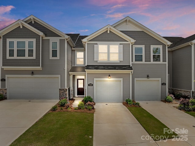 5625 Axil Ln, Charlotte, NC 28269 - view of front of house with an attached garage, driveway, stone siding, and a lawn