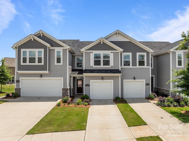 5625 Axil Ln, Charlotte, NC 28269 - view of front of property with an attached garage, driveway, and stone siding