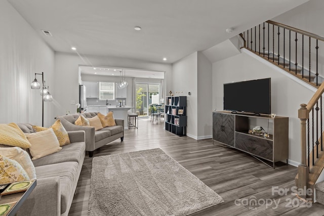 5625 Axil Ln, Charlotte, NC 28269 - living room with wood finished floors, stairway, recessed lighting, and baseboards