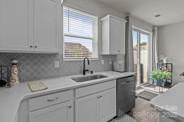 5625 Axil Ln, Charlotte, NC 28269 - kitchen with a sink, dishwasher, light countertops, and backsplash