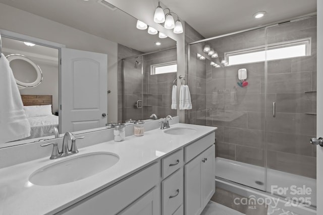5625 Axil Ln, Charlotte, NC 28269 - ensuite bathroom featuring double vanity, a stall shower, and recessed lighting