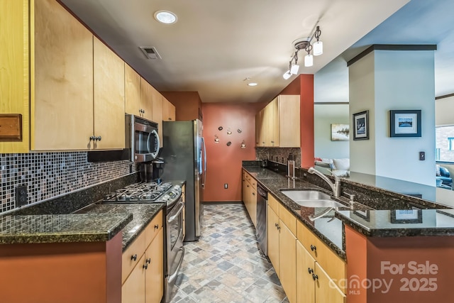 715 N Church St Unit 613, Charlotte, NC 28202 - kitchen featuring appliances with stainless steel finishes, a sink, a peninsula, decorative backsplash, and light brown cabinetry