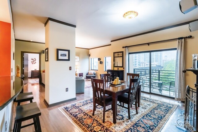 715 N Church St Unit 613, Charlotte, NC 28202 - dining space with ornamental molding, light wood-type flooring, and baseboards