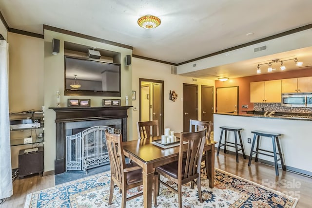 715 N Church St Unit 613, Charlotte, NC 28202 - dining room featuring light wood-style flooring and a fireplace