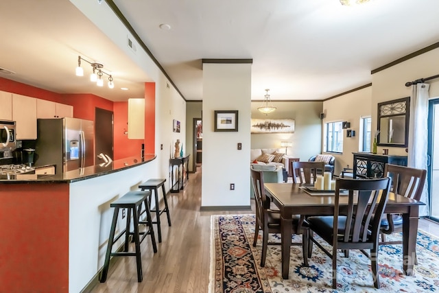 715 N Church St Unit 613, Charlotte, NC 28202 - dining space with light wood-style floors, baseboards, and crown molding