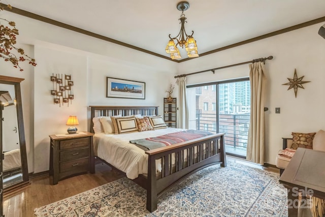 715 N Church St Unit 613, Charlotte, NC 28202 - bedroom with access to exterior, wood finished floors, baseboards, and a chandelier