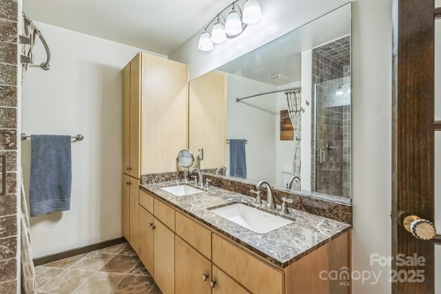 715 N Church St Unit 613, Charlotte, NC 28202 - full bathroom featuring tiled shower and double vanity
