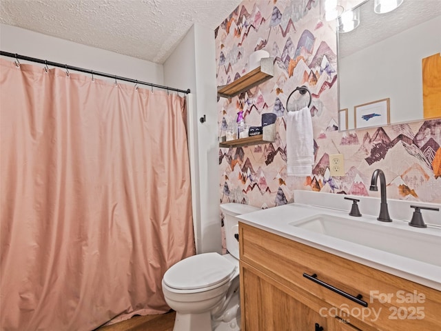 full bath featuring a textured ceiling, toilet, vanity, and curtained shower