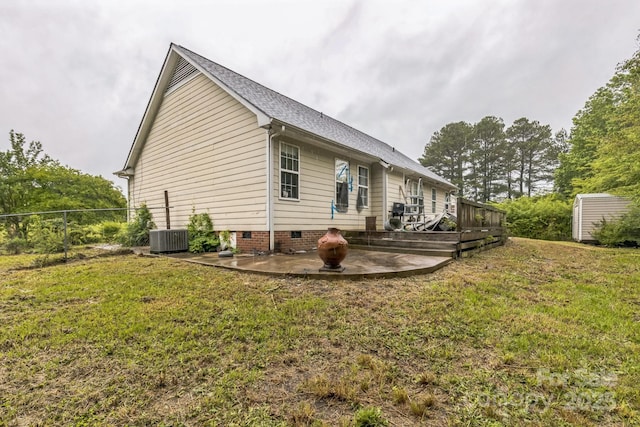 113 Stacy Ln, Raeford Township, NC 28376 - view of side of property featuring a patio area, a wooden deck, crawl space, a shingled roof, and an outbuilding