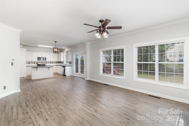 11526 Mcginns Trace Ct, Charlotte, NC 28277 - unfurnished living room featuring ornamental molding, baseboards, light wood-type flooring, and a ceiling fan