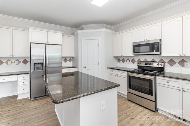 11526 Mcginns Trace Ct, Charlotte, NC 28277 - kitchen featuring appliances with stainless steel finishes, light wood-style flooring, tasteful backsplash, dark stone counters, and white cabinetry