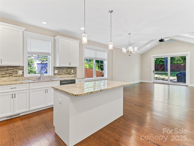 kitchen featuring a sink, dark wood finished floors, backsplash, vaulted ceiling, and recessed lighting