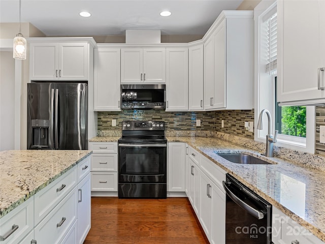 kitchen with stainless steel appliances, a sink, white cabinetry, and recessed lighting