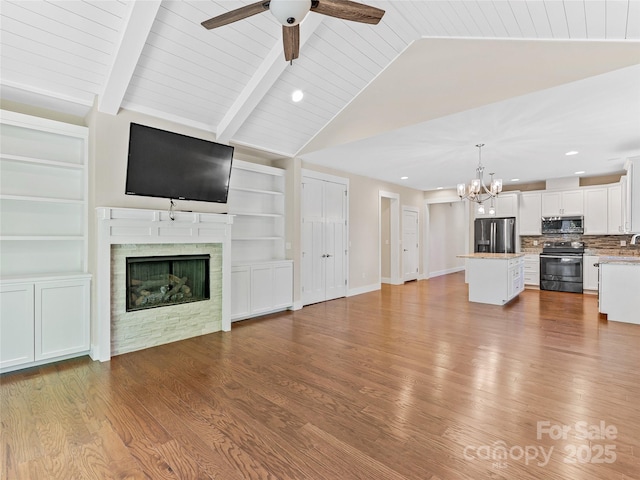unfurnished living room with a chandelier, wood finished floors, built in features, and recessed lighting